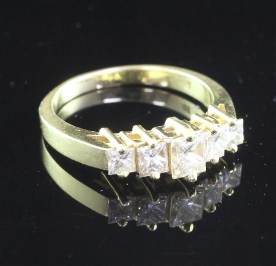 An 18ct gold and graduated five stone princess cut diamond half hoop ring, size P.